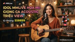 Banner hồ sơ Idol cover nhạc MMLive Họa Mi, ID phòng 558899. Hình ảnh nữ streamer xinh đẹp đang ôm đàn guitar acoustic mỉm cười trước micro trong không gian ấm cúng, kèm dòng chữ 'Giọng ca acoustic triệu view' và tên miền invglobal.io.