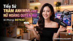 Banner hồ sơ idol Trâm Anh MMLive, giới thiệu 'Nữ hoàng quyến rũ!' với ID phòng 867530. Hình ảnh một nữ streamer trẻ mỉm cười trước thiết bị livestream, với các biểu tượng trái tim và kim cương bay lên. Bao gồm domain invglobal.io.